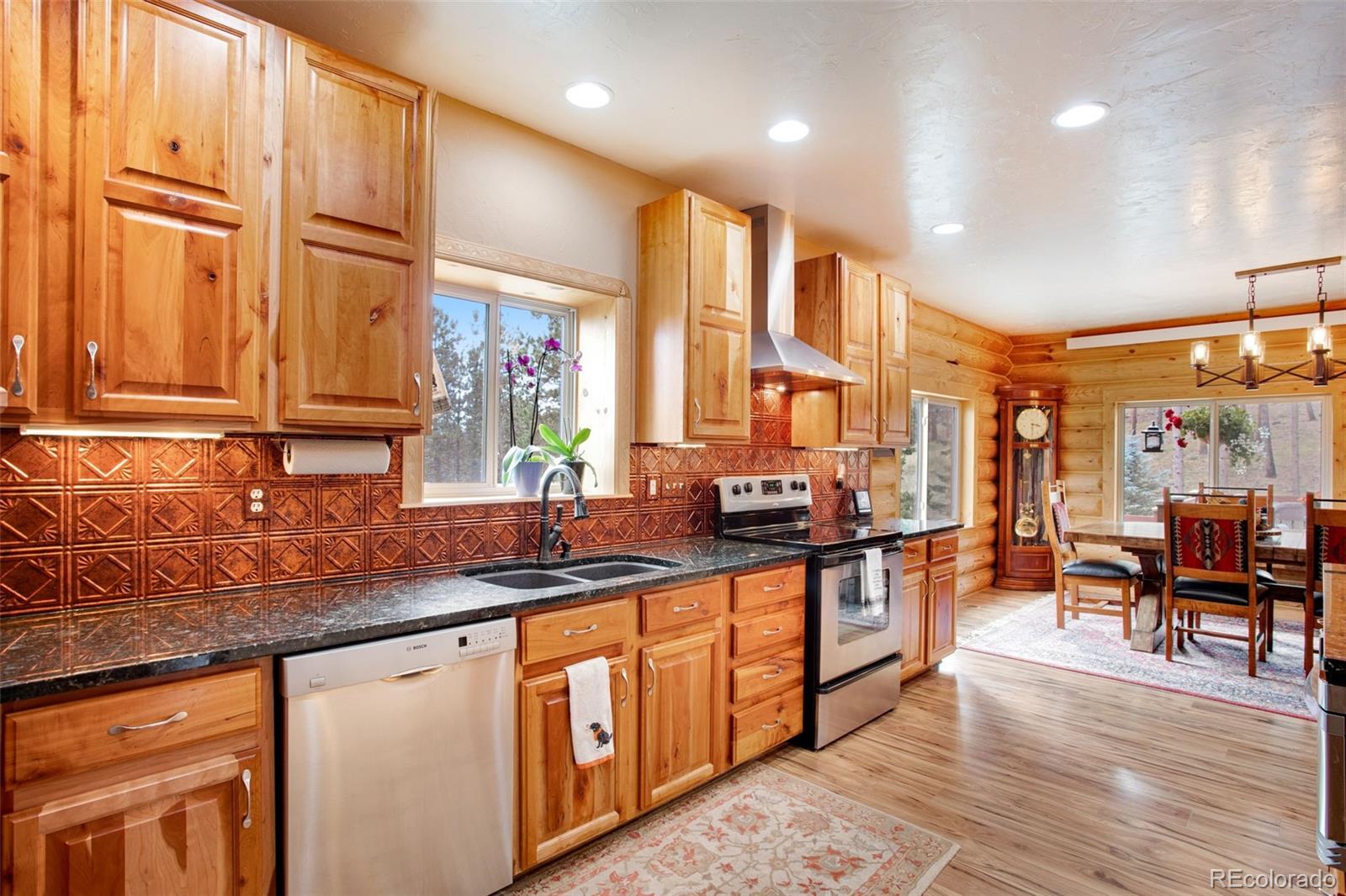 427 Wilderness Ridge Way Bellvue, CO 80512 - Photo 23 of 50 a kitchen with stainless steel appliances granite countertop a stove a sink and a refrigerator