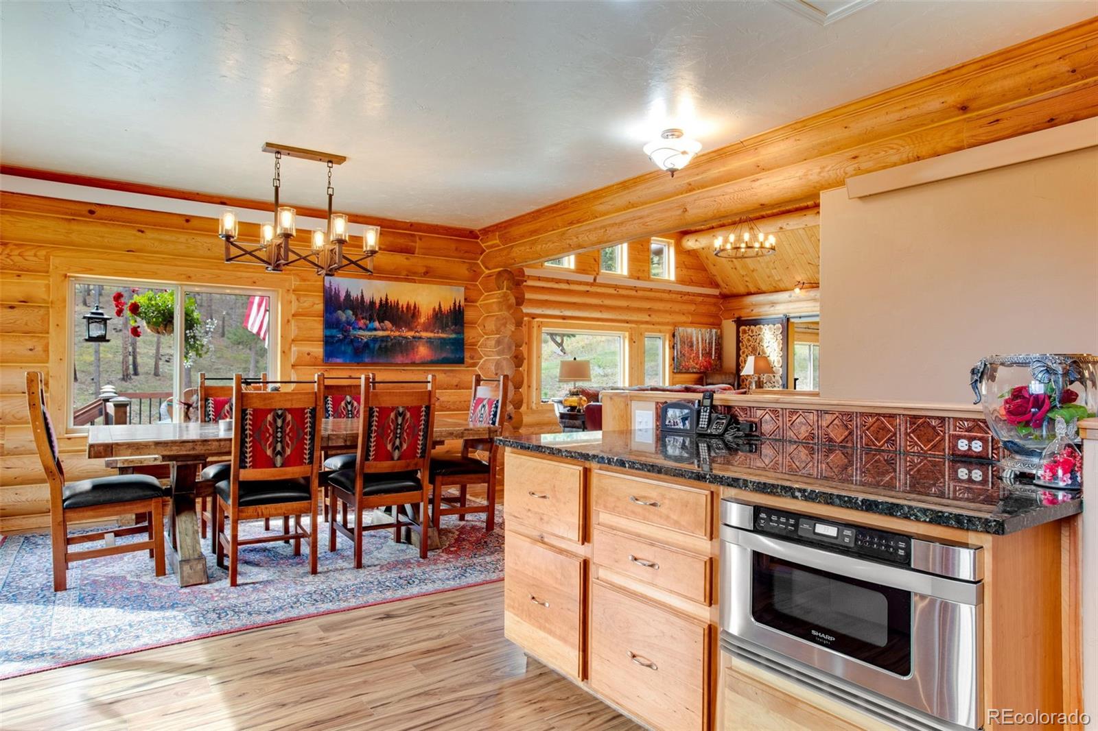 427 Wilderness Ridge Way Bellvue, CO 80512 - Photo 24 of 50 a kitchen with stainless steel appliances granite countertop a stove and a wooden floors