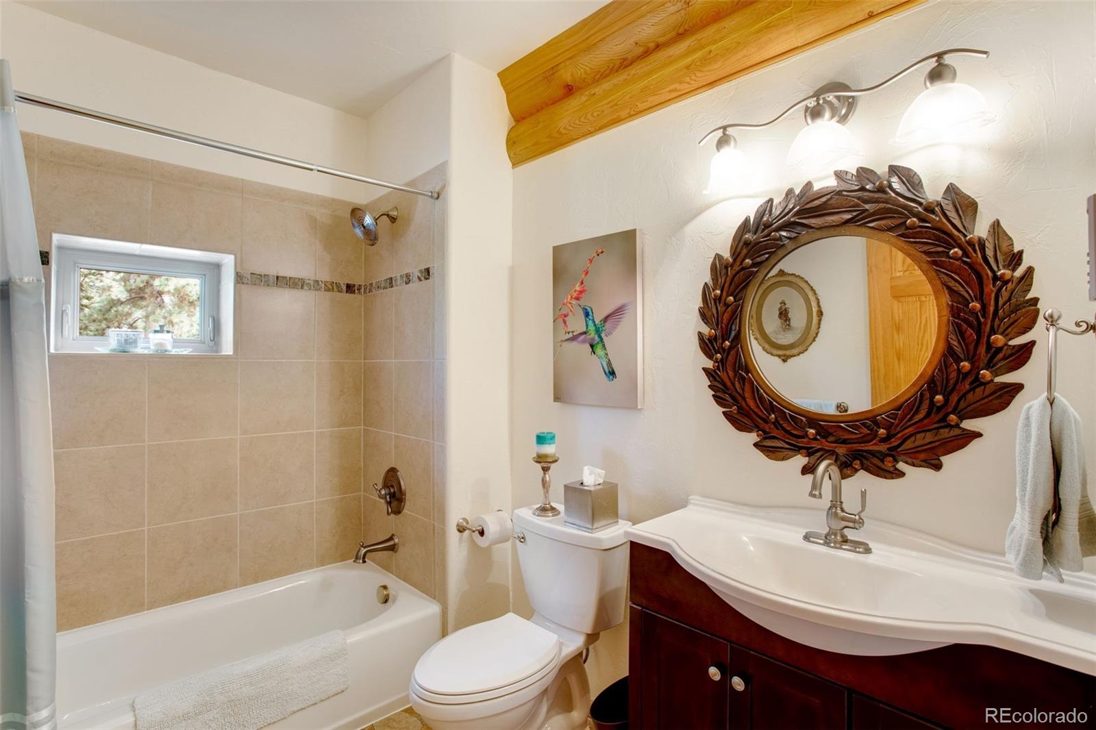 427 Wilderness Ridge Way Bellvue, CO 80512 - Photo 35 of 50 a bathroom with a sink a toilet and a mirror