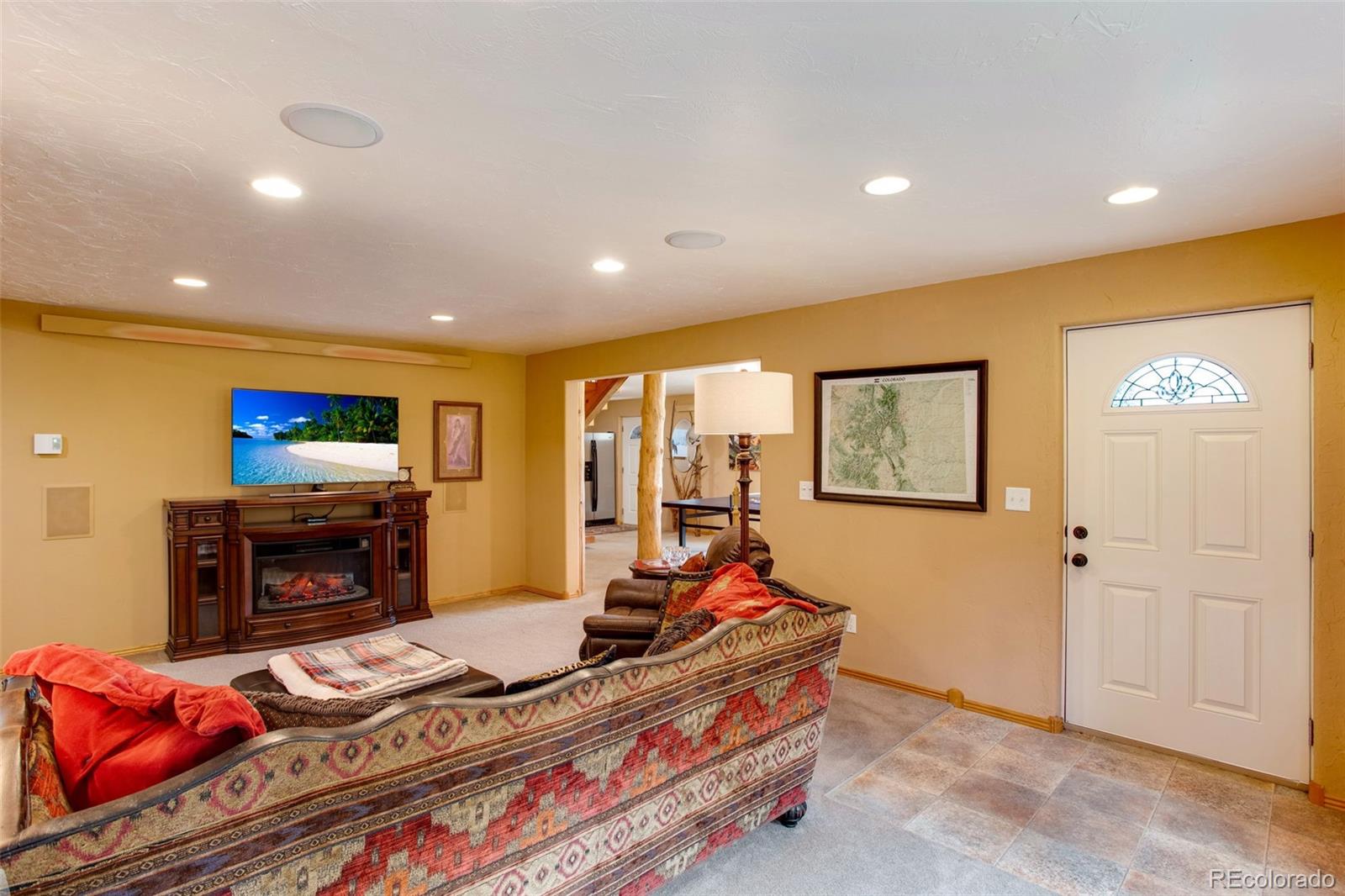 427 Wilderness Ridge Way Bellvue, CO 80512 - Photo 42 of 50 a living room with furniture flat screen tv and a fireplace