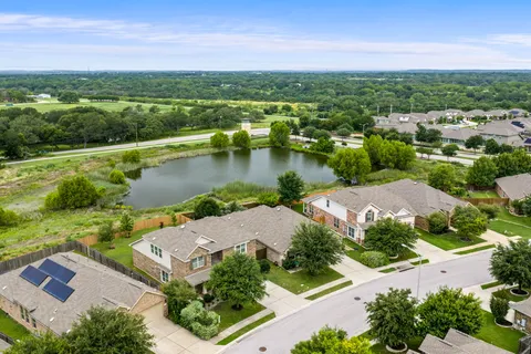 an aerial view of a house with a lake view