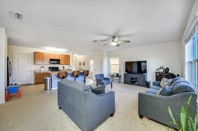 a view of a dining room with furniture and a window