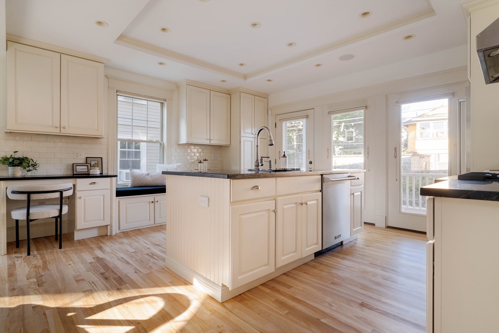 54 Orchard Street, Unit 1 Boston, MA 02130 - Photo 13 of 36 a kitchen with white cabinets sink and white appliances