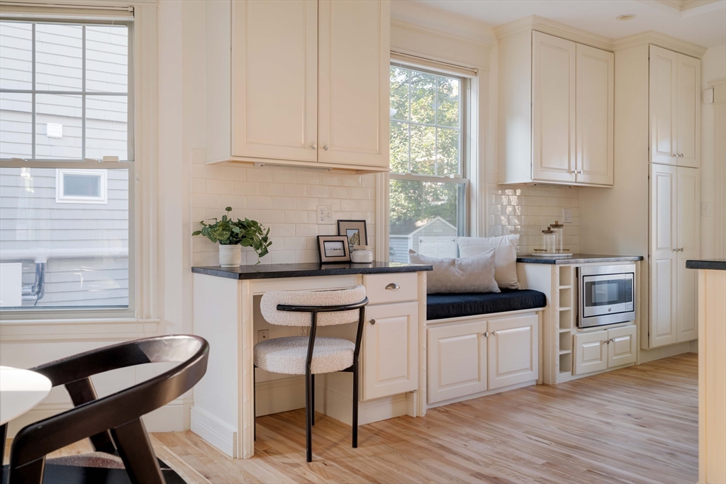 54 Orchard Street, Unit 1 Boston, MA 02130 - Photo 14 of 36 a kitchen with white cabinets and appliances