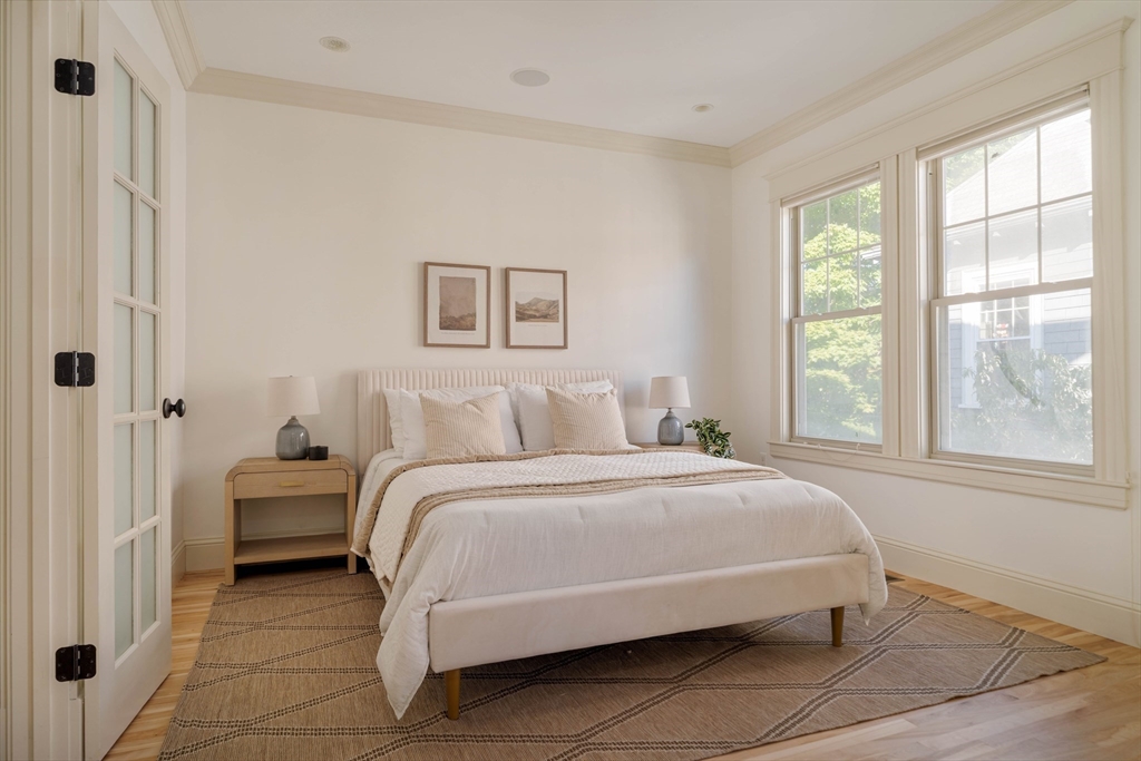 54 Orchard Street, Unit 1 Boston, MA 02130 - Photo 17 of 36 a bedroom with a bed and a large window