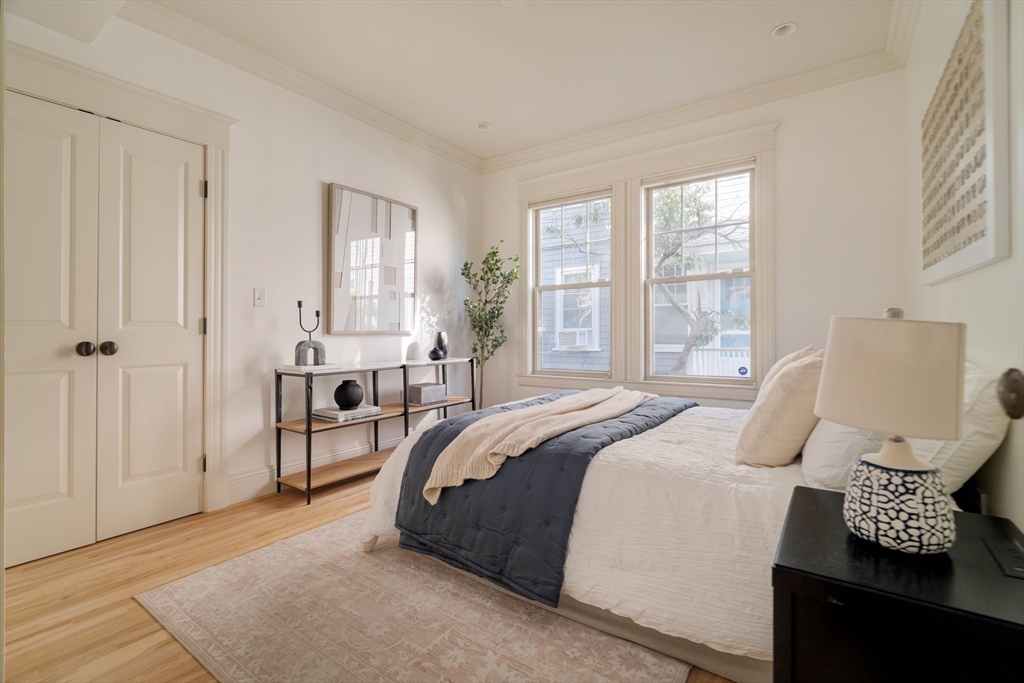 54 Orchard Street, Unit 1 Boston, MA 02130 - Photo 20 of 36 a bedroom with a bed and wooden floor