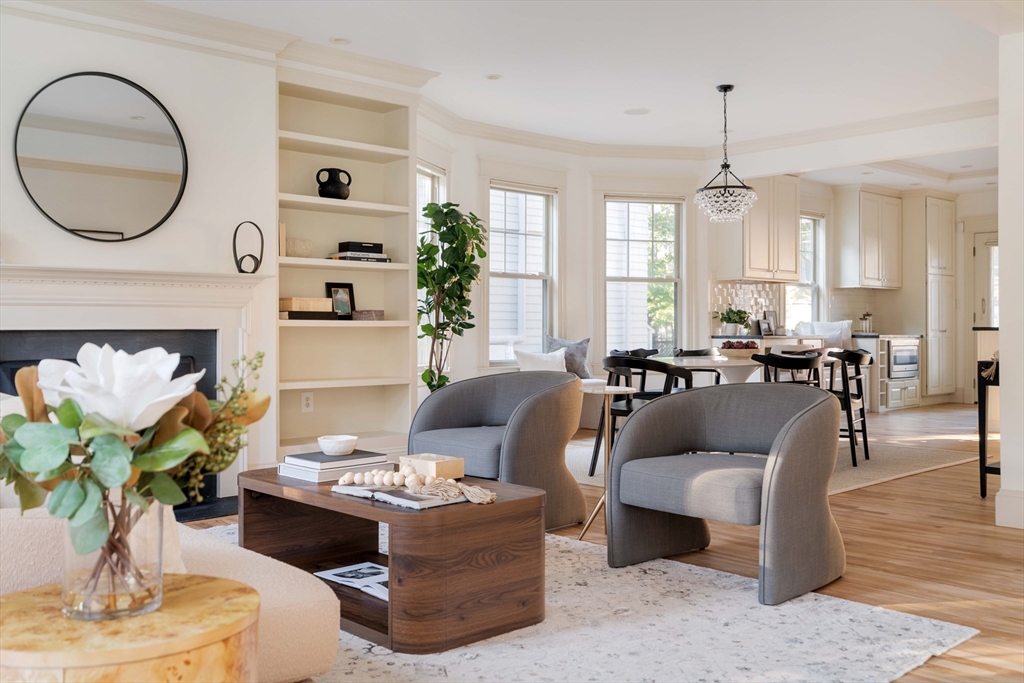 54 Orchard Street, Unit 1 Boston, MA 02130 - Photo 2 of 36 a living room with furniture a chandelier and a fireplace