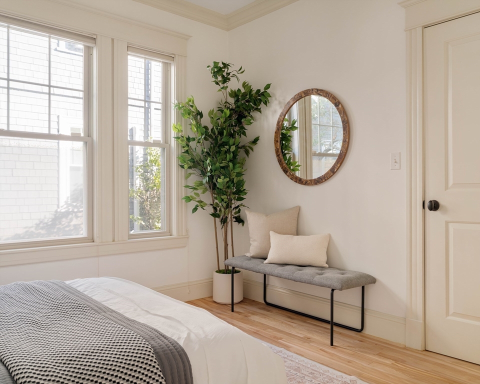 54 Orchard Street, Unit 1 Boston, MA 02130 - Photo 23 of 36 a bedroom with a bed and a potted plant next to a window