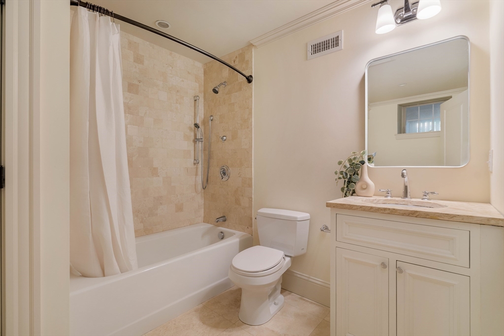 54 Orchard Street, Unit 1 Boston, MA 02130 - Photo 31 of 36 a bathroom with a toilet a sink and a bathtub