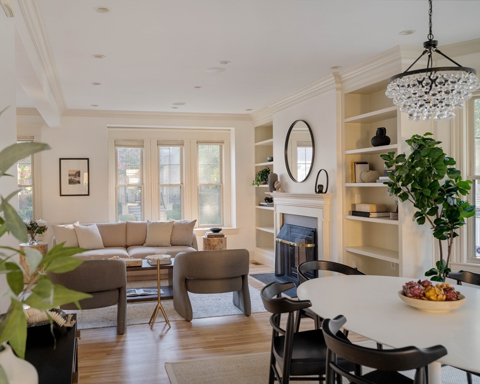 54 Orchard Street, Unit 1 Boston, MA 02130 - Photo 6 of 36 a living room with furniture a fireplace and a chandelier