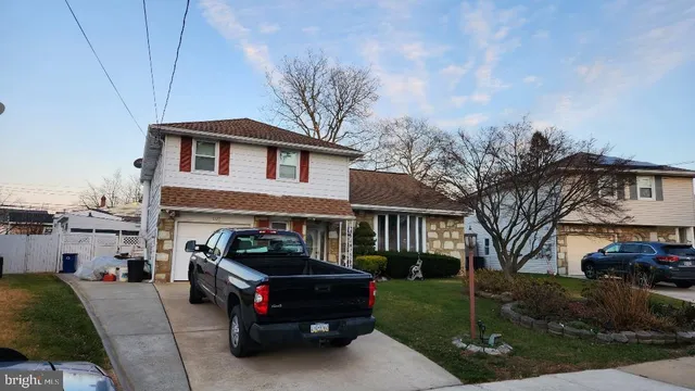 a car parked in front of white house