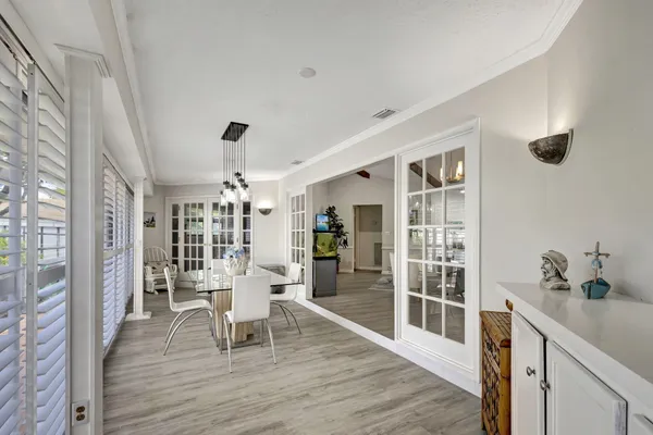 a view of a dining room with furniture and chandelier