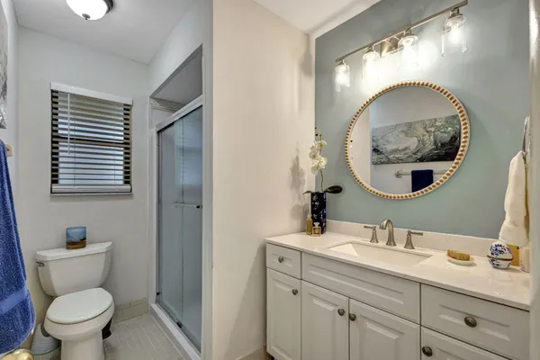 a spacious bathroom with a toilet sink and mirror