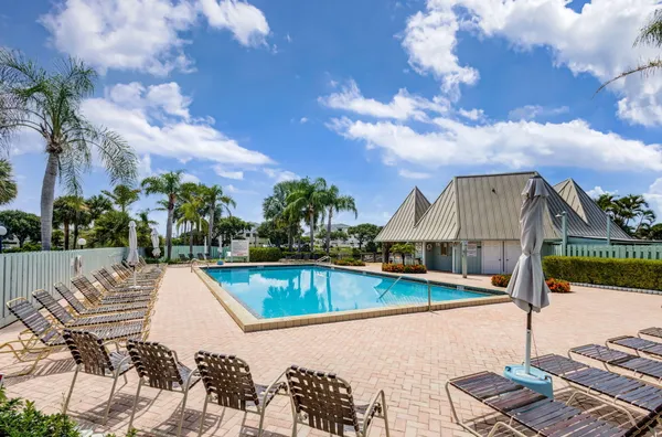a view of swimming pool with lawn chairs