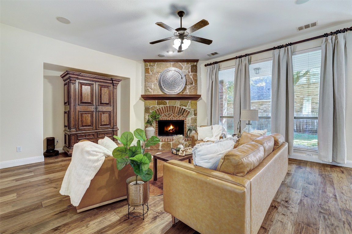 3600 Alexandrite Way Round Rock, TX 78681 - Photo 15 of 40 a living room with furniture a fireplace and a floor to ceiling window