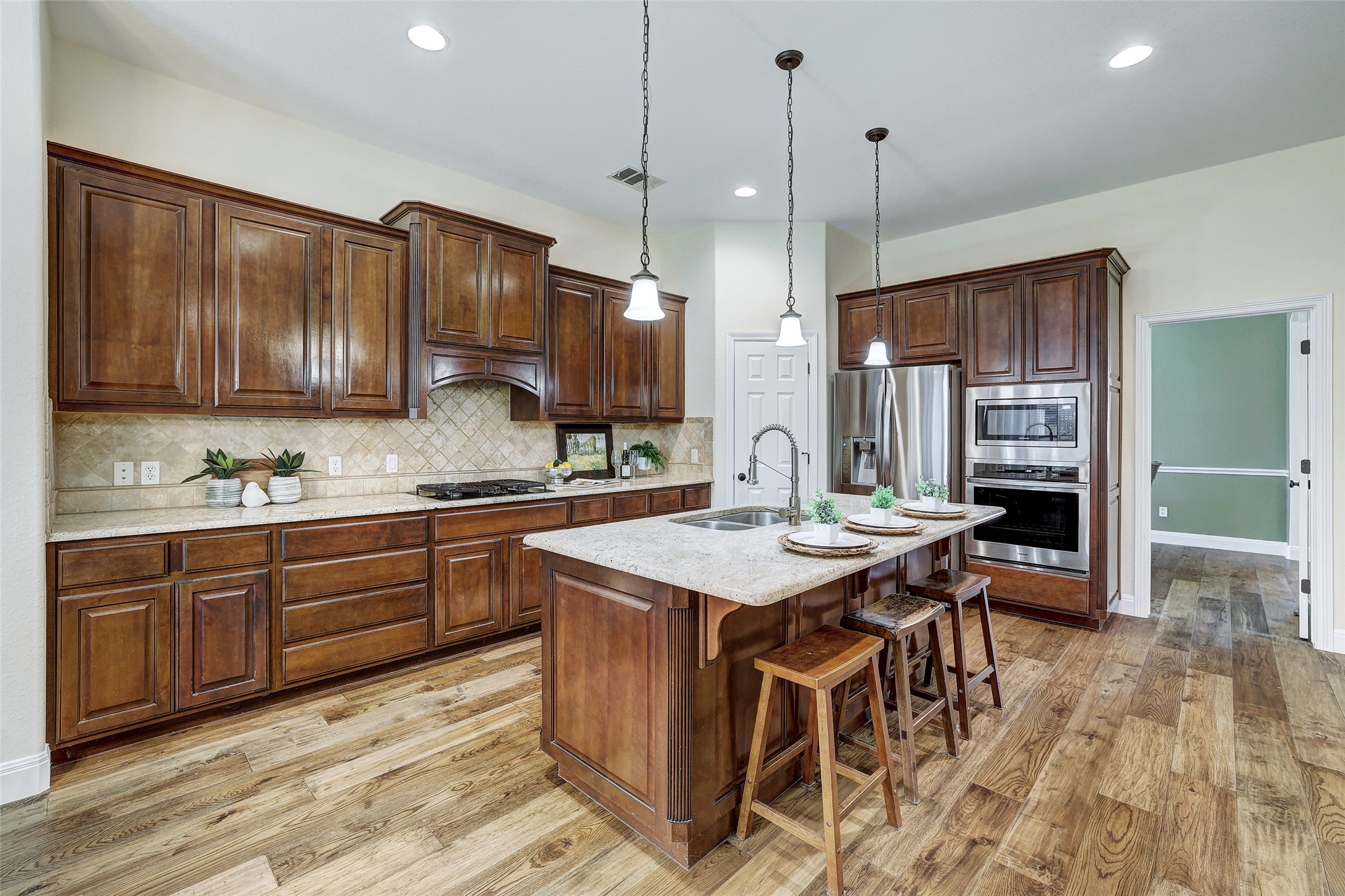 3600 Alexandrite Way Round Rock, TX 78681 - Photo 15 of 40 a kitchen with sink cabinets and wooden floor