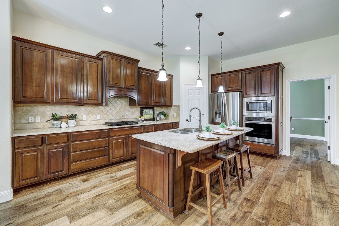 3600 Alexandrite Way Round Rock, TX 78681 - Photo 17 of 40 a kitchen with sink cabinets and wooden floor