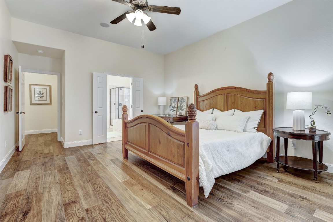 3600 Alexandrite Way Round Rock, TX 78681 - Photo 19 of 40 a spacious bedroom with a bed and a chandelier