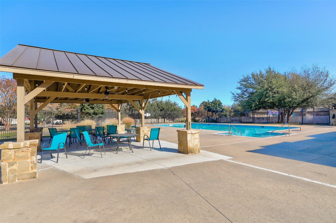 3600 Alexandrite Way Round Rock, TX 78681 - Photo 40 of 40 a view of a patio with a table and chairs under an umbrella