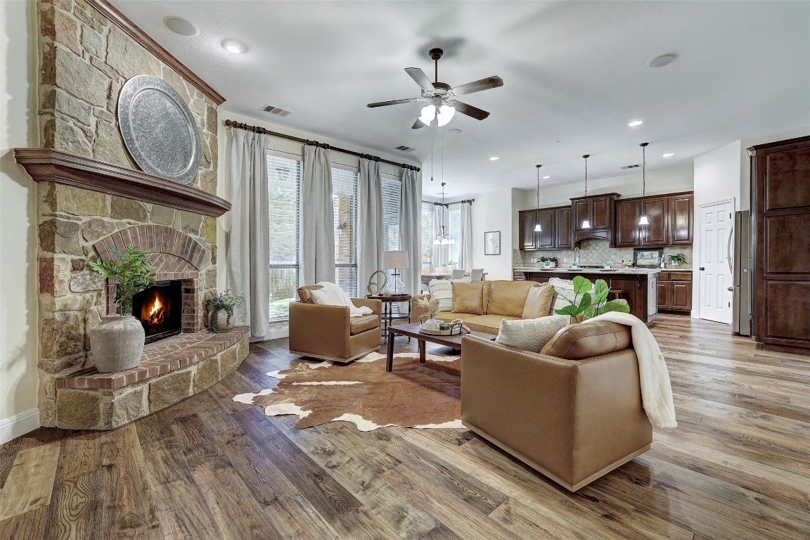 3600 Alexandrite Way Round Rock, TX 78681 - Photo 4 of 40 a living room with furniture a fireplace and kitchen view