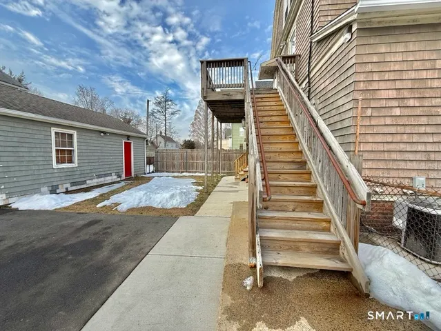 a view of a balcony with wooden floor and fence
