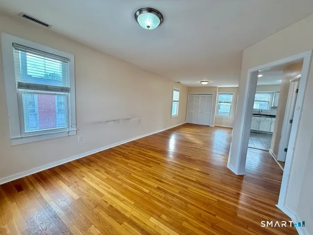a bathroom with a toilet sink vanity and mirror