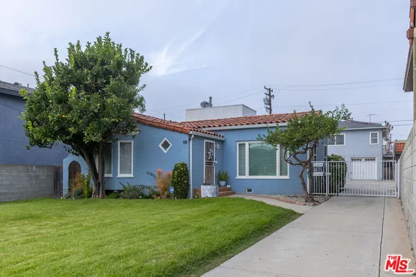 a front view of a house with a yard and a garage