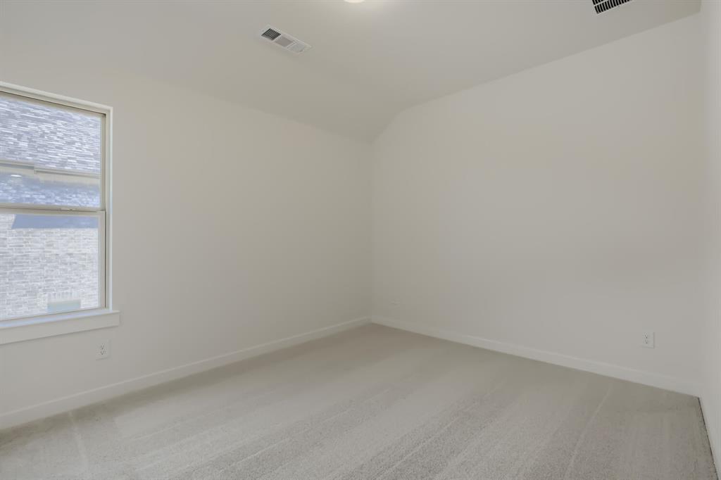 824 Stone Grv Road Lavon, TX 75166 - Photo 14 of 26 Carpeted interior room featuring a window with white trim, light-colored walls, and a sloped ceiling