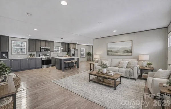 a living room with furniture wooden floor and kitchen view