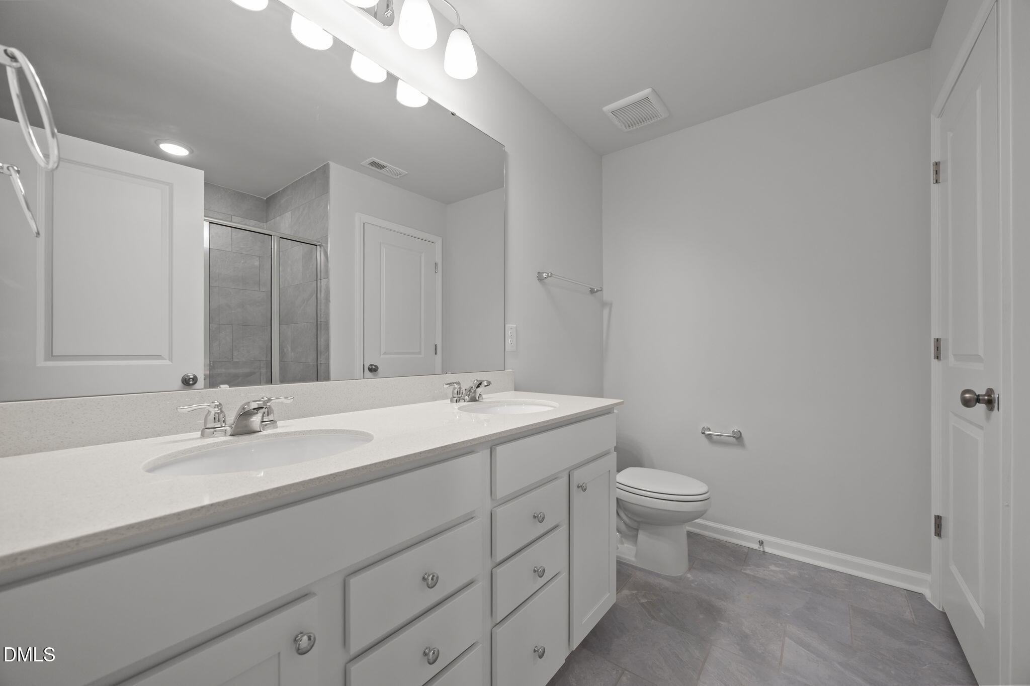 272 Fosterton Cottage Way Raleigh, NC 27603 - Photo 11 of 35 a bathroom with a double vanity sink mirror and toilet