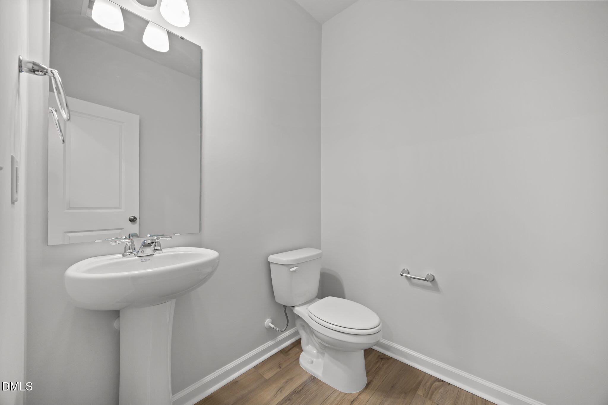 272 Fosterton Cottage Way Raleigh, NC 27603 - Photo 22 of 35 a bathroom with a sink a mirror and a toilet