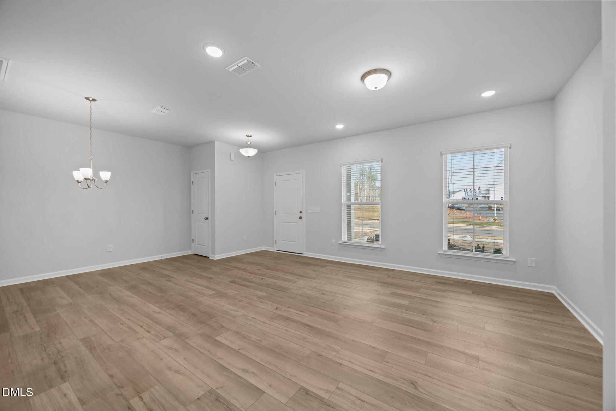 272 Fosterton Cottage Way Raleigh, NC 27603 - Photo 29 of 35 a view of an empty room with wooden floor and a window