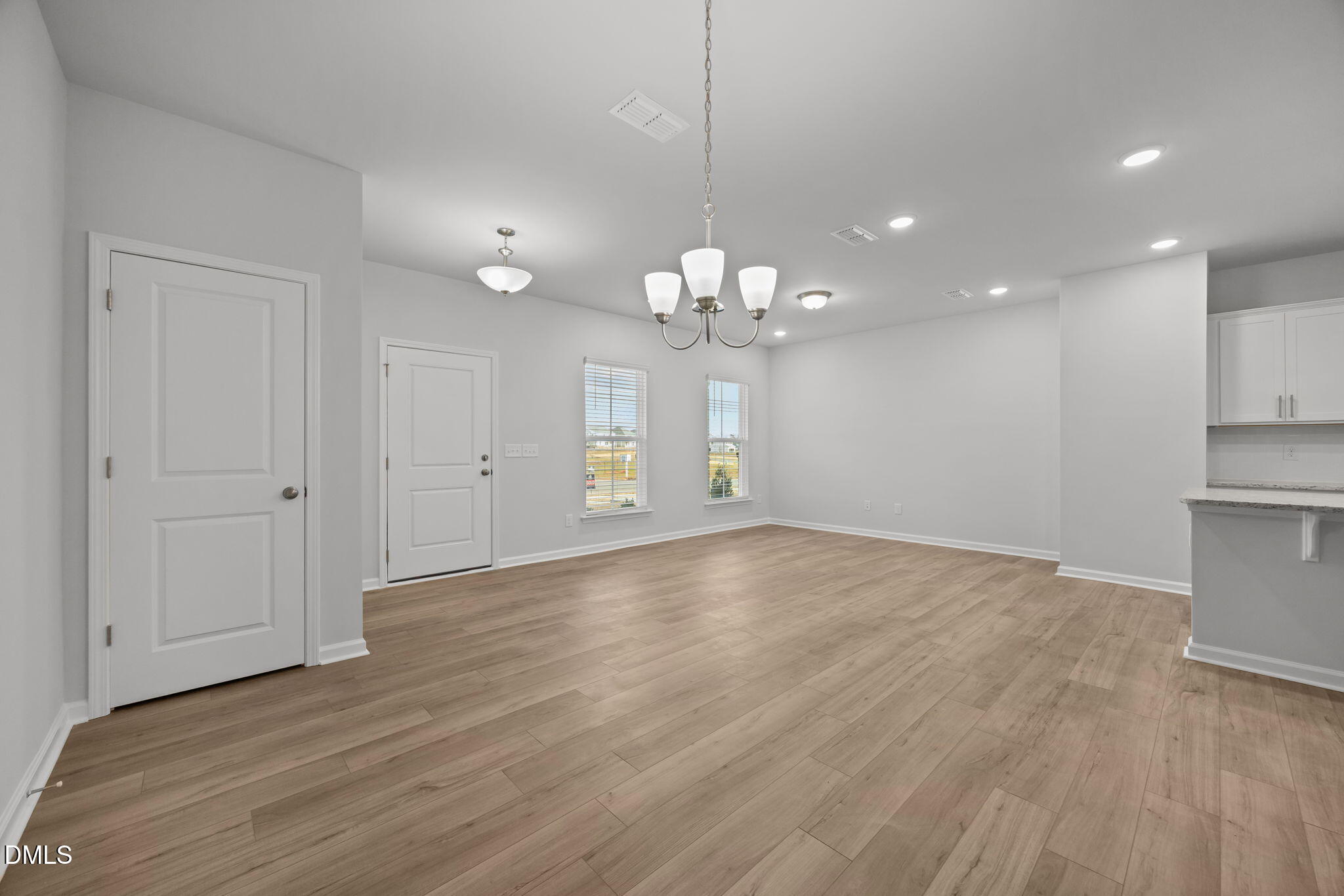 272 Fosterton Cottage Way Raleigh, NC 27603 - Photo 32 of 35 an empty room with wooden floor and windows