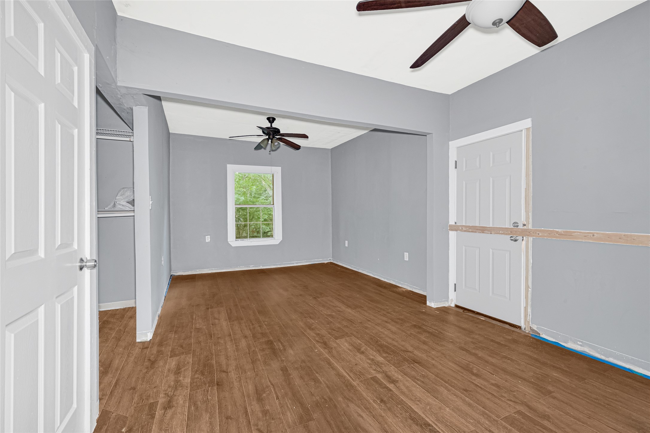 7305 Tremper Street Houston, TX 77020 - Photo 12 of 28 wooden floor in an empty room with a window