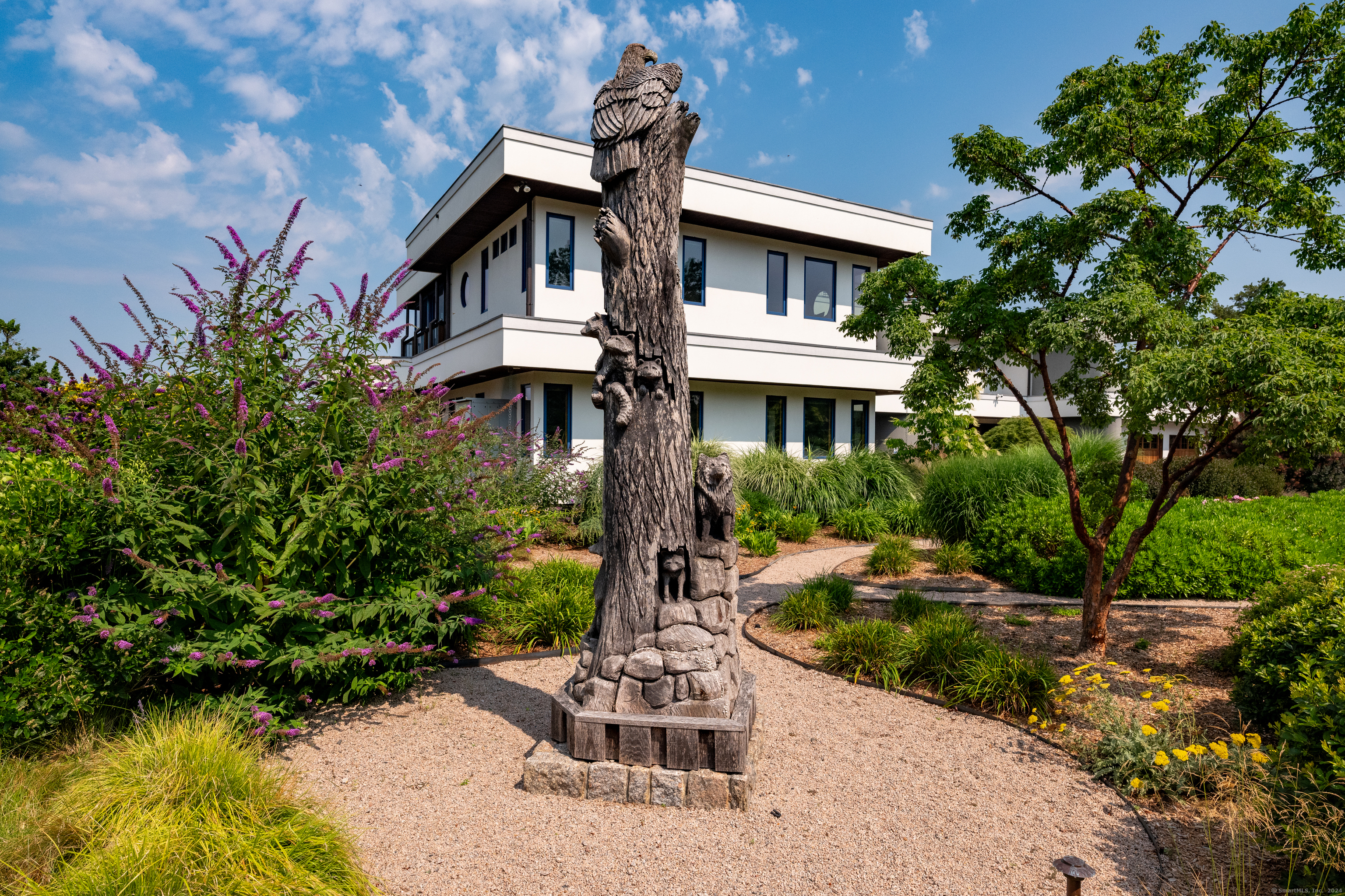 215 Uncas Point Road Guilford, CT 06437 - Photo 11 of 40 a front view of a house with garden