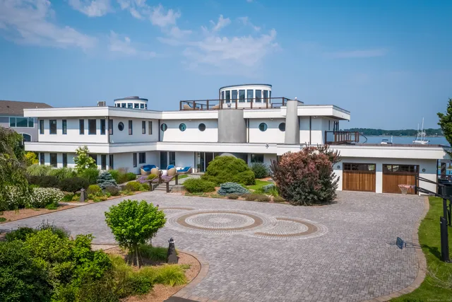 a living room with fireplace furniture and a floor to ceiling window