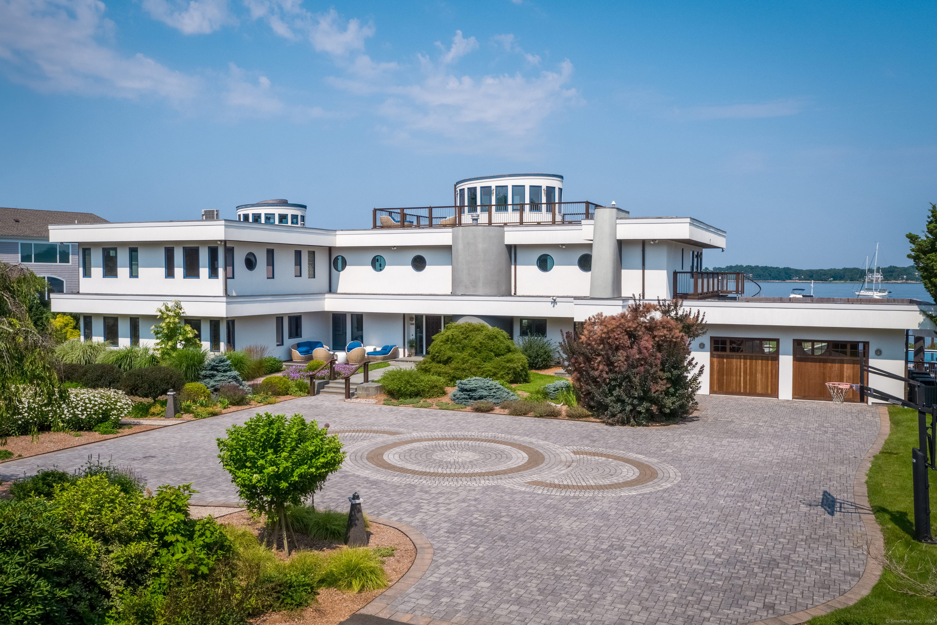 215 Uncas Point Road Guilford, CT 06437 - Photo 13 of 40 a front view of a house with a yard and potted plants