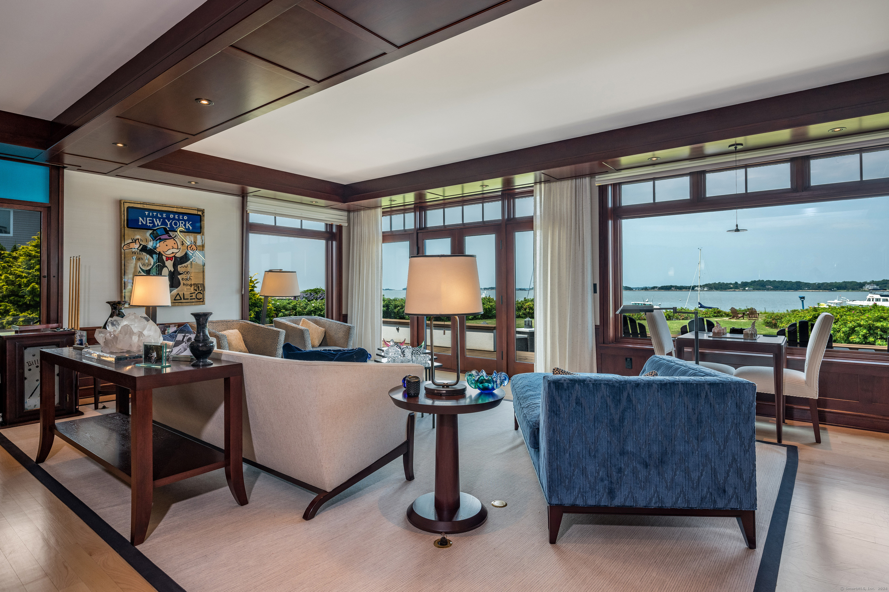 215 Uncas Point Road Guilford, CT 06437 - Photo 15 of 40 a living room with fireplace furniture and a floor to ceiling window