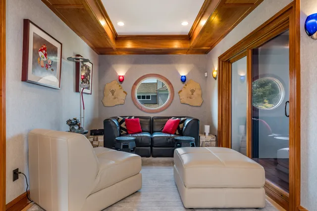 a roof deck with a table and chairs with wooden floor and fence