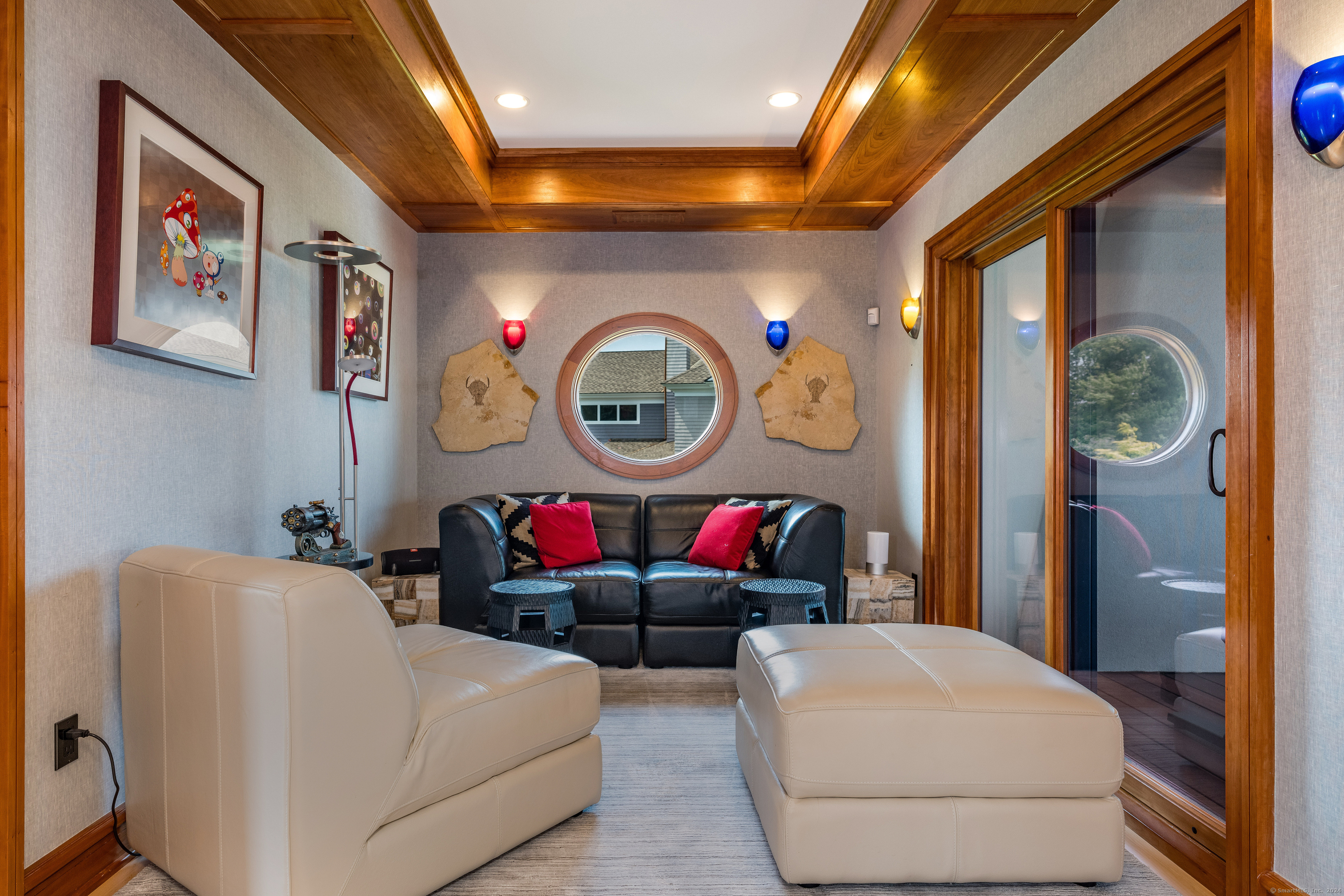 215 Uncas Point Road Guilford, CT 06437 - Photo 23 of 40 a living room with furniture a clock and a large window