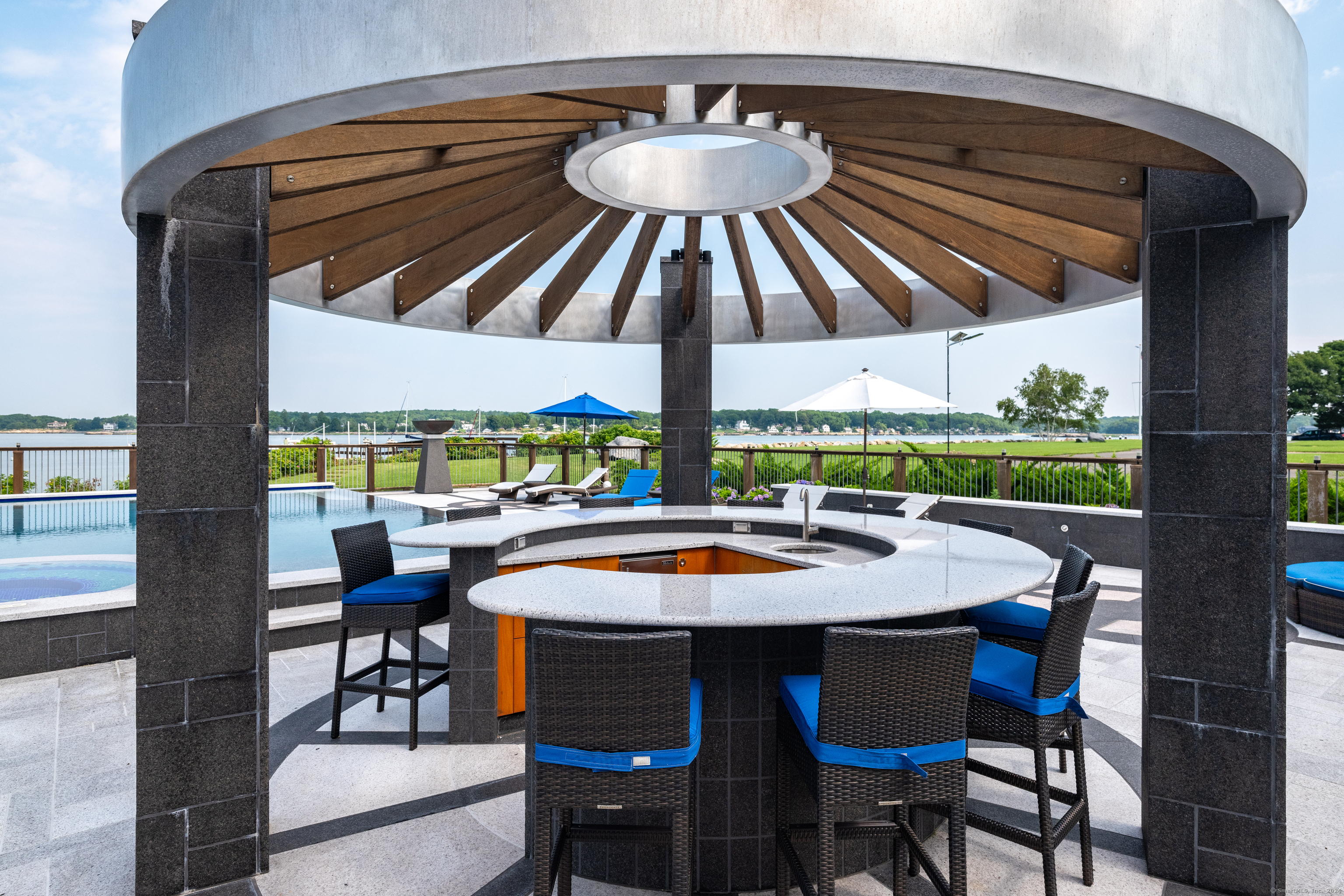 215 Uncas Point Road Guilford, CT 06437 - Photo 25 of 40 a outdoor dining space with furniture and umbrella