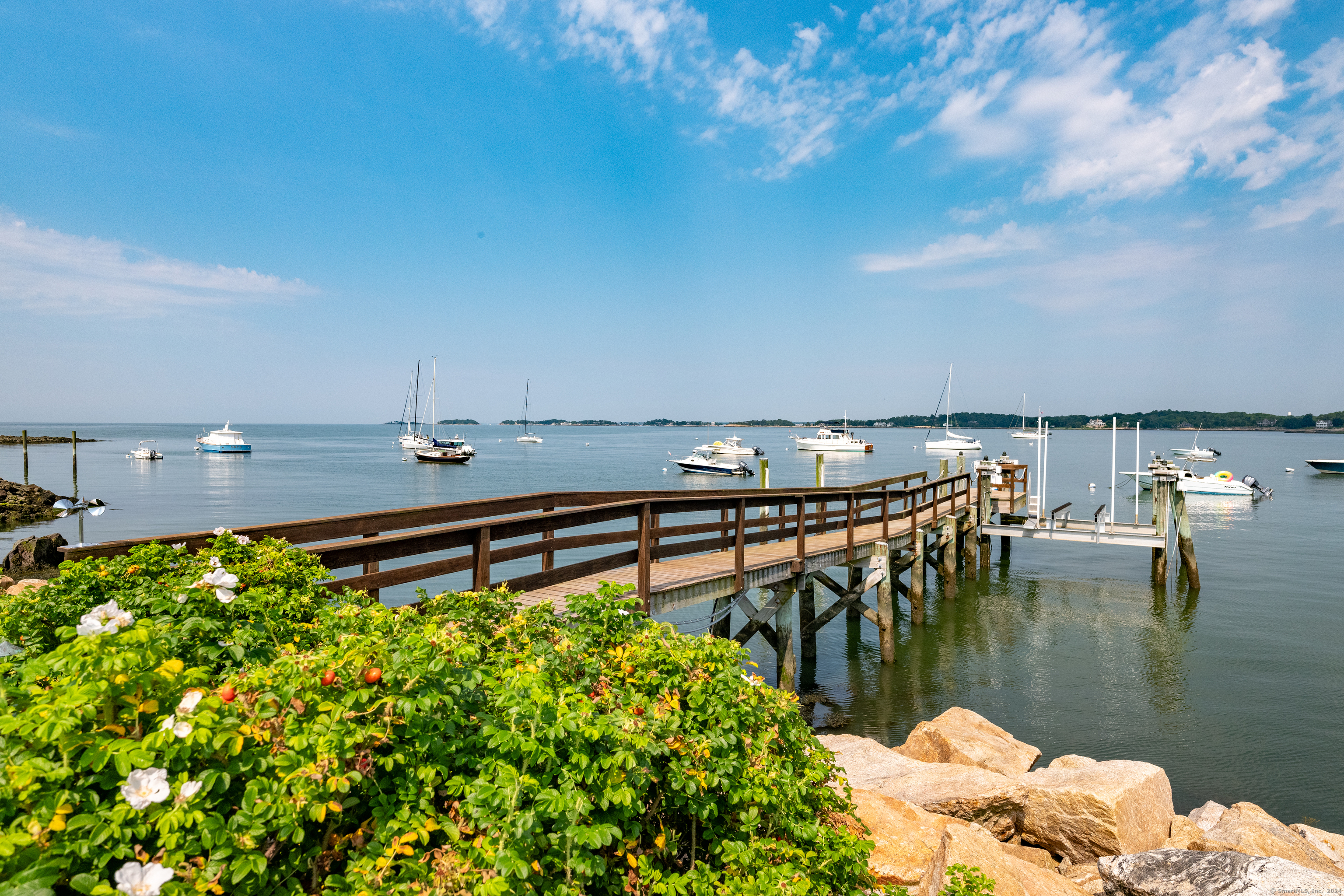 215 Uncas Point Road Guilford, CT 06437 - Photo 28 of 40 a view of a lake with a car parked