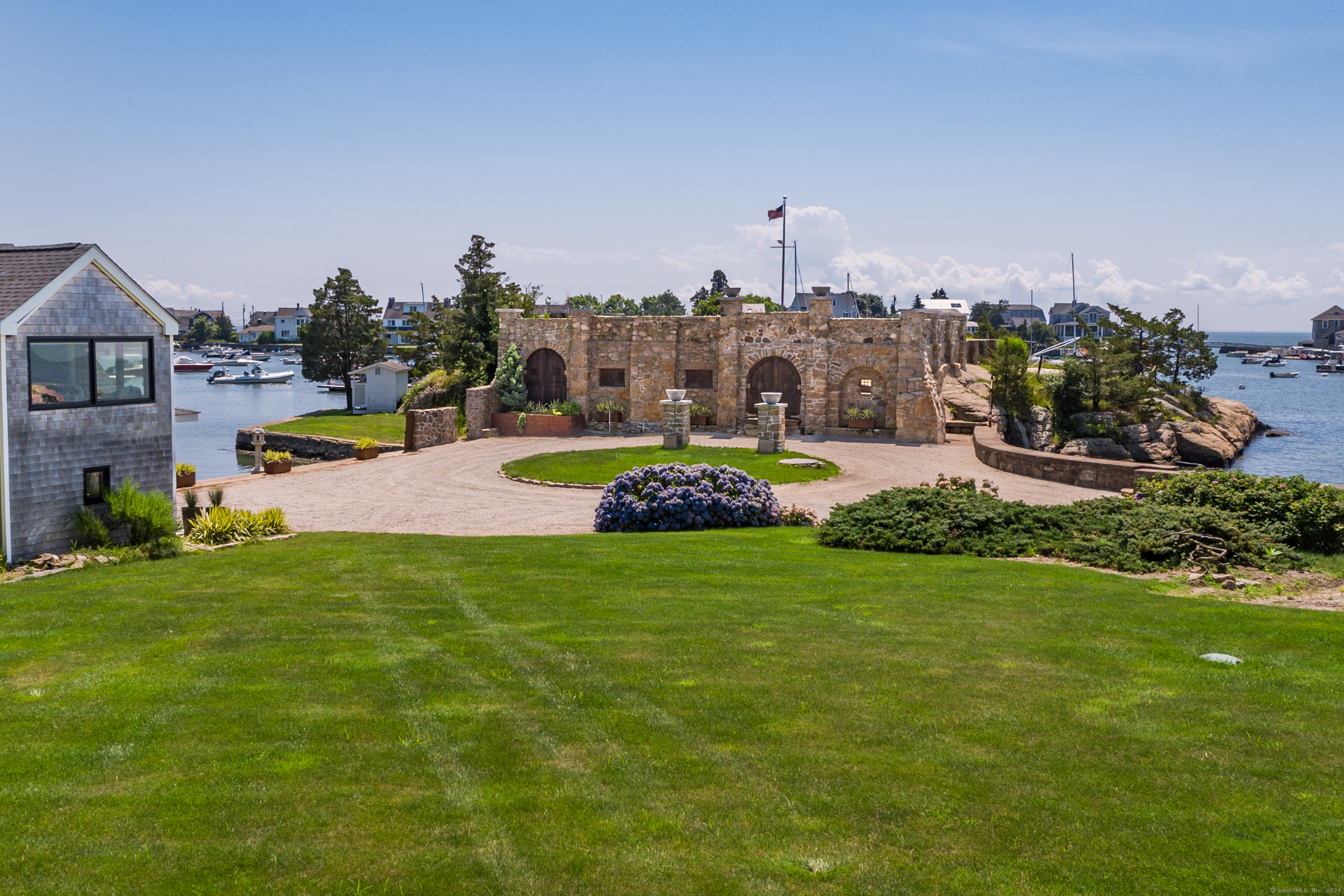 215 Uncas Point Road Guilford, CT 06437 - Photo 32 of 40 a view of a house with a big yard and large trees