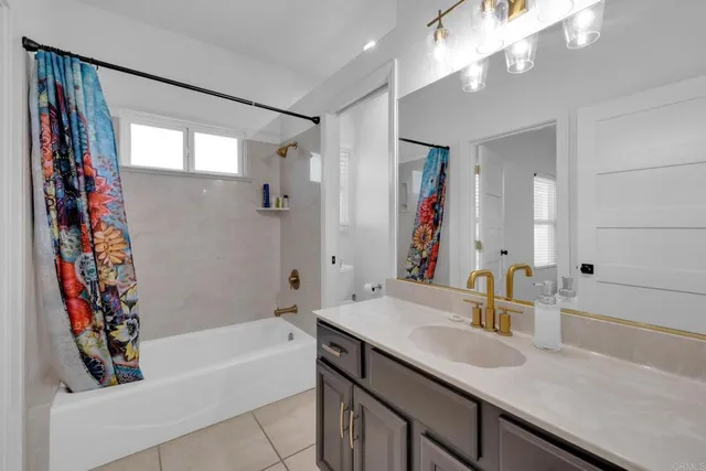 a bathroom with a bathtub a sink and a large mirror