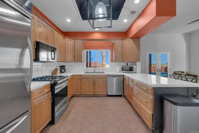 a kitchen with a sink stainless steel appliances and cabinets