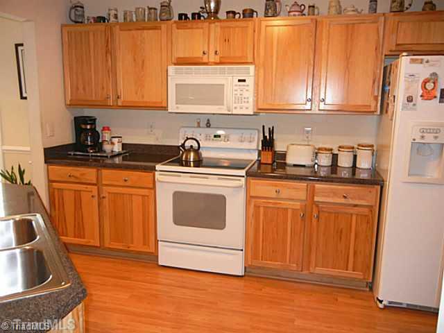 8625 Circle Drive Rural Hall, NC 27045 - Photo 5 of 16 Kitchen. Kitchen has a dishwasher, smooth top stove, built in microwave and side by side refrigerator. All kitchen appliances remain.