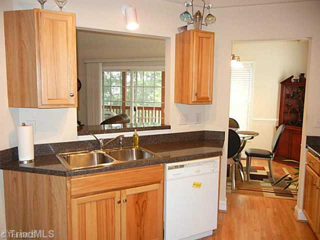 8625 Circle Drive Rural Hall, NC 27045 - Photo 6 of 16 Kitchen. Another view of the kitchen shows it open to the Great Room. Laminate flooring in the kitchen, Dining area and foyer.