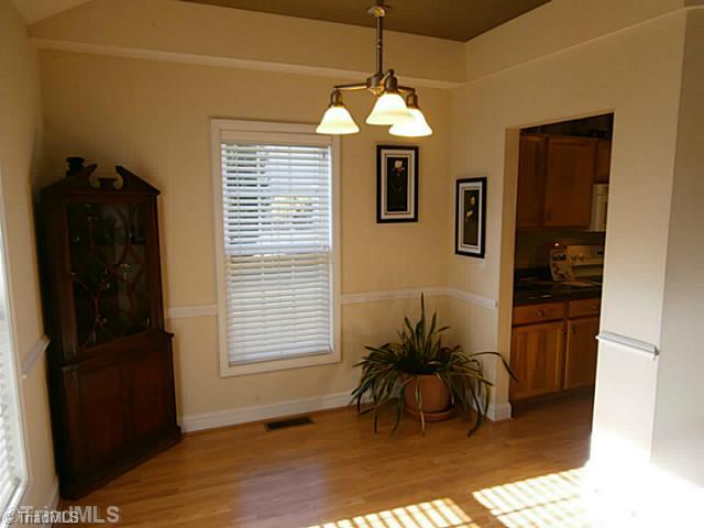 8625 Circle Drive Rural Hall, NC 27045 - Photo 7 of 16 Dining Room. Dining area has chair rail and laminate flooring and 2" blinds. Notice the screened porch just steps away.