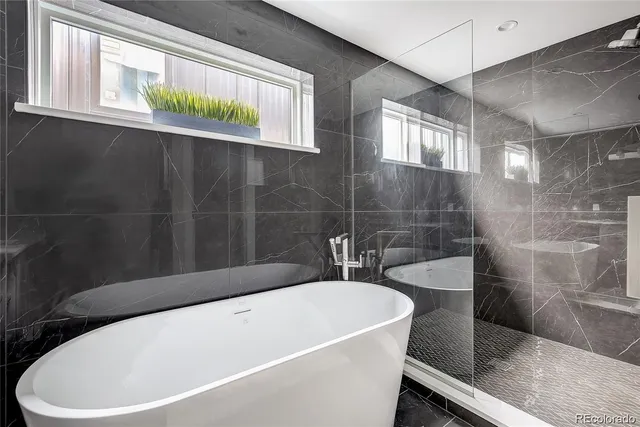 a white bath tub sitting next to a white sink