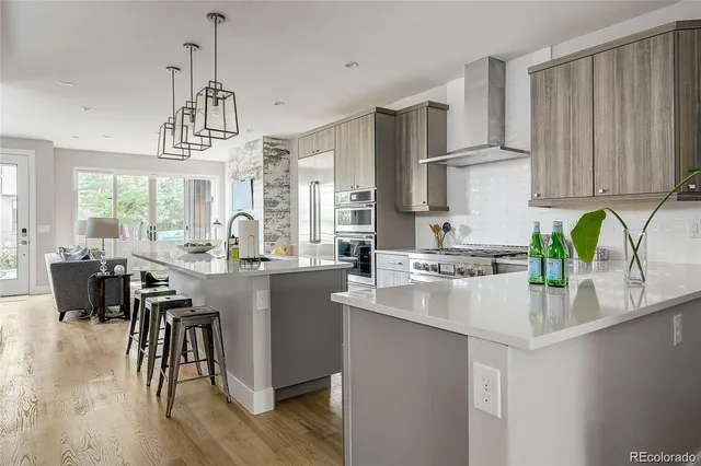 a kitchen with kitchen island granite countertop a sink cabinets and wooden floor